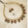 Handmade terracotta necklace set featuring Red lotus motifs with matching earrings on a natural fabric background.